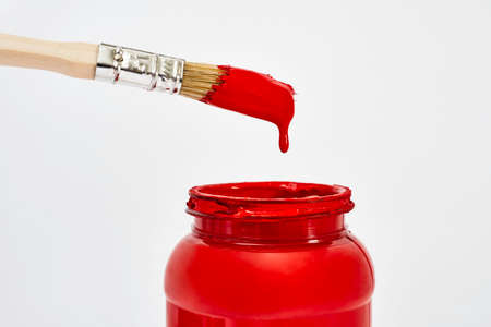 Brush with red paint drawing a heartの写真素材