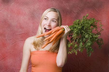 woman eating carrotsの写真素材