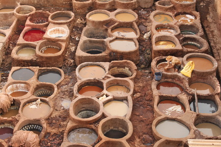 Traditional tannery in Fez in Morocco -family business. People dye leathers using natural dyes to give different colors.の写真素材