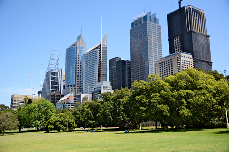 Australia; Sydney October 25th 2018 -View on business centre with skyscrappers. People relaxing on the grass in city parkのeditorial素材