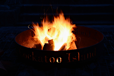 Fireplace on Cockatoo Island in Sydney. Wood is burning by night on campsiteの写真素材
