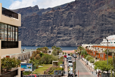 Los Gigantes - coastlie with a range of volcanic mountaines; view from centre of town with one of main streetのeditorial素材