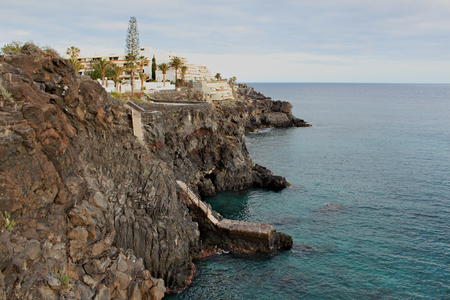 Costa del Silencio - high volcanic coast with rock formation in the Silence Bay with clear turquoise water of the oceanの写真素材