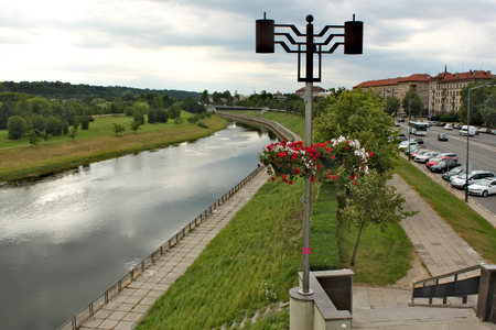 View from a city bridge on Neman river in Kaunas along the street with old buildingsの写真素材