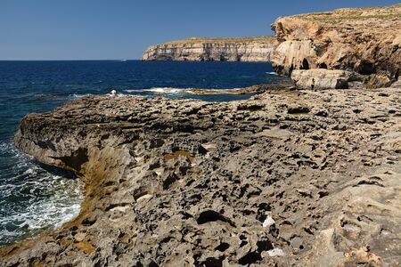 Dwejra Bay, with its dramatic coastal formations and sea spilling over the rocks, is a magical attraction. Here you can swim in the spectacular deep sea of the bayの写真素材