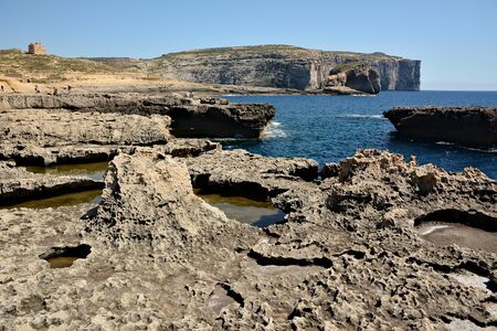 Dwejra Bay, with its dramatic coastal formations and sea spilling over the rocks, is a magical attraction. Here you can swim in the spectacular deep sea of the bayの写真素材