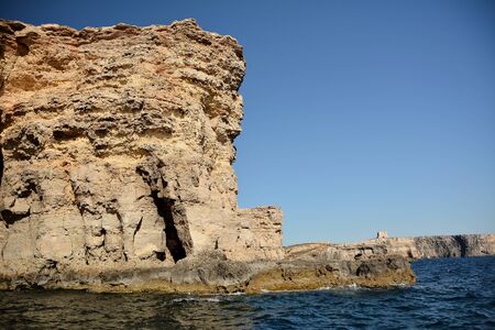 High cilfs with caves on Cominotto Island, near famous Comino Islandの写真素材
