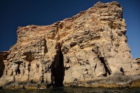 High cilfs with caves on Cominotto Island, near famous Comino Islandの写真素材