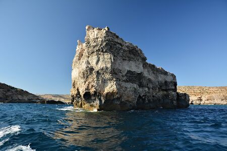 High cilfs with caves on Cominotto Island, near famous Comino Islandの写真素材