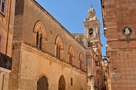 One of the old town streets of Mdina/Rabat with historical buildings and decorative carvingsの写真素材