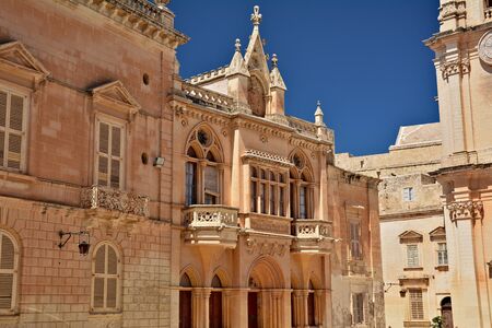 One of the old town streets of Mdina/Rabat with historical buildings and decorative carvingsの写真素材
