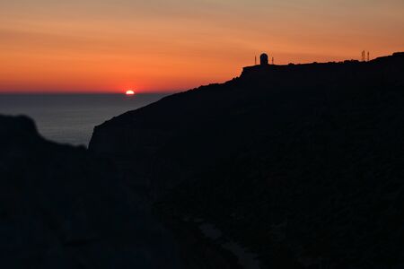 Sunsent at the Dingli Cliffs on Malta. Rocky terrain with Mediterraean Sea on the horizon.の写真素材