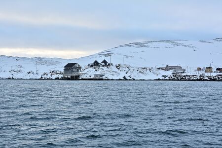 Skarsvag is a village in Nordkapp Municipality. The village lies along the northern coast of the island of MagerÃ¸ya, and it claims the distinction of being the world's northernmost fishing village. Houses on a hill full of snow during winter time.の写真素材