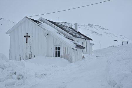 White, wooden church -  parish church of the Church of Norway in Nordkapp Municipality duirn winter...