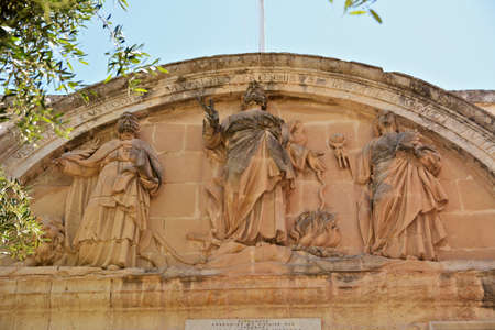 Malta, Rabat, June 4th 2019  - Architectonical carvings at the gate to the Old Town of Mdina; tourists walking on the bridgeのeditorial素材
