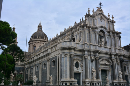 Facade of the baroque cathedral church with sculptures and entrance doorの写真素材