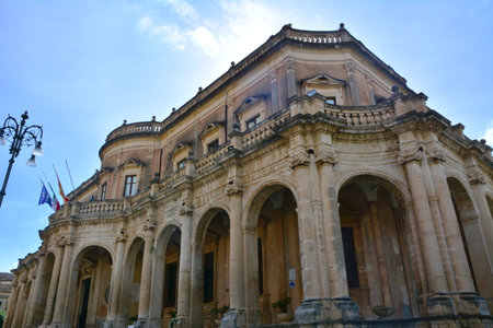 Ducezio Palace -main historic buildings in Noto, located in Piazza XVI Maggio. It was built in the 1700s as a private residence, and today houses the Museo Civico di Noto. The palace is decorated with Baroque elements, such as stone statues and stucco decorations.の写真素材