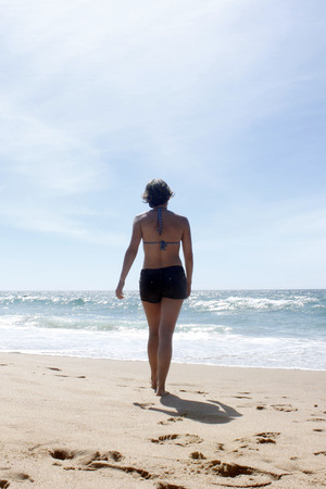 woman walking on the beachの写真素材