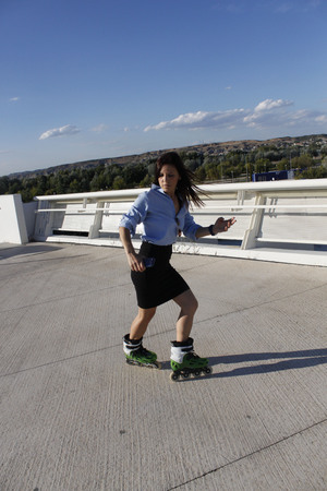woman skating backwards inline a sunny dayの写真素材