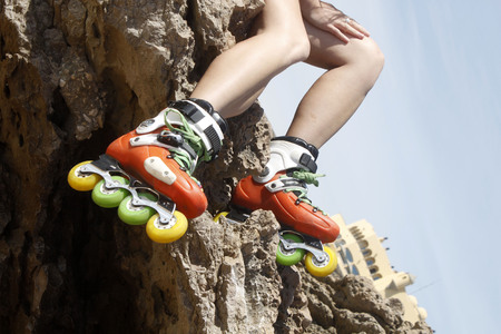 legs with skates in a rock and a building in Cascais, Lisbon, Portugalの写真素材