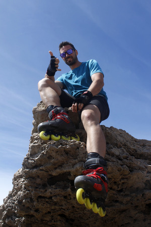 Guy on a rock with his hand okの写真素材
