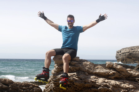 man on a rock with his arms openの写真素材