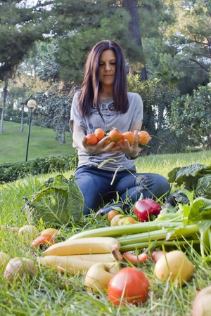 woman with mandarins on her handsの写真素材