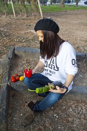 woman with vegetables sit in a parkの写真素材