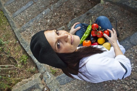 woman with vegetables in a stairsの写真素材