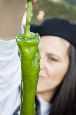 woman behind a green pepperの写真素材