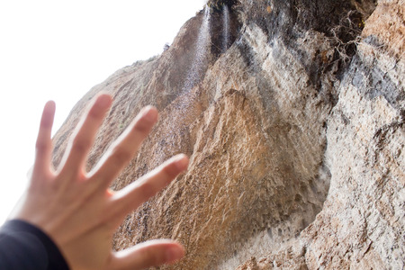hand in front of a waterfallの写真素材