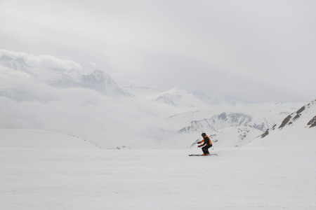 guy skiing down the mountainの写真素材