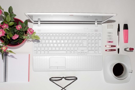 Laptop and pink things to use in an office