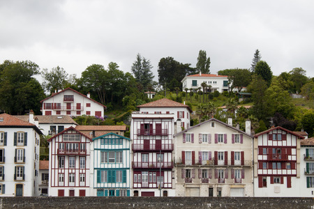 Houses between trees in a cloudy day in Saint Jean de Luz, Franceの写真素材