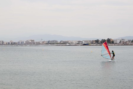 guy windsurfing near the coast in Spain in a cloudy dayの写真素材
