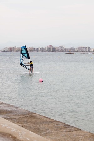 girl windsurfing near the coast of Rosas in Spainの写真素材