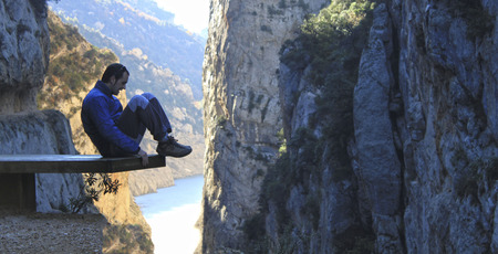 Guy over a table high in the mountains over de riverの写真素材