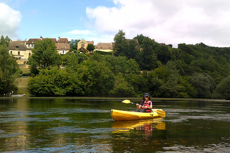 girl in a yellow canoe in the river, having funの写真素材