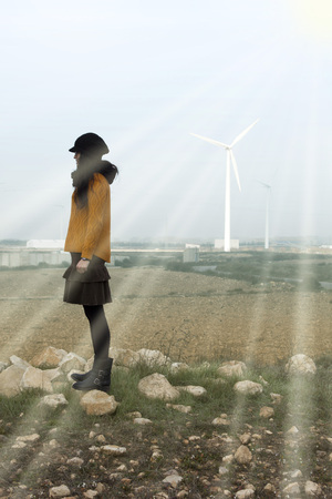 girl close to mills wind in a sunny dayの写真素材