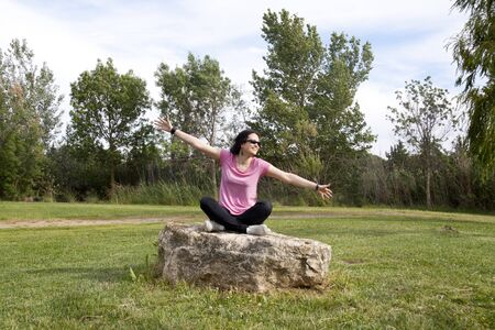woman celebrating something in a parkの写真素材