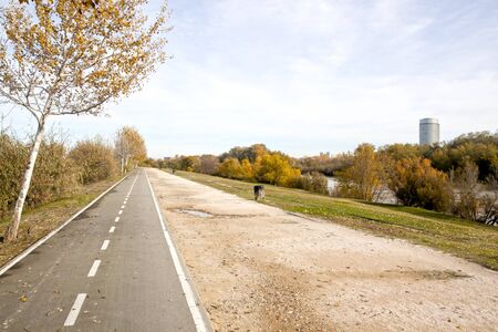 bikeway in a park in front of the water tower in Zaragoza, Spainの写真素材