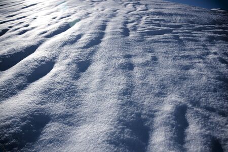 snow surface in the night with waves in winterの写真素材