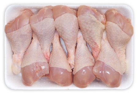 Photo of chicken legs on plastic plate isolated on white backgroundの写真素材