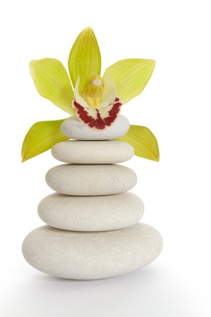Pyramid of stones with orchid above themの写真素材