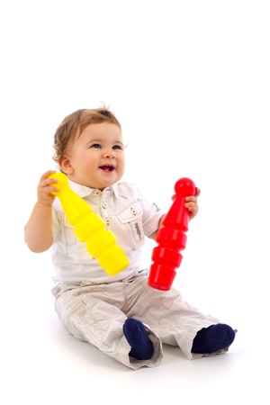 Little boy playing with two skittles and looking upの写真素材