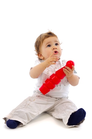 Baby boy playing with skittle, looking upの写真素材