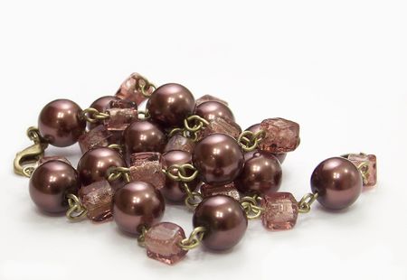 brown necklace with round and cube beads on white backgroundの写真素材
