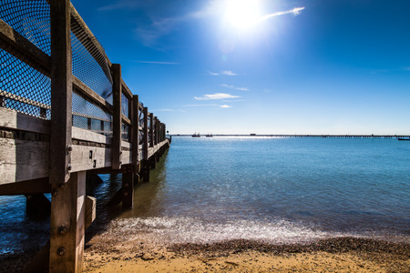Wooden Jetty with Blue Sky in Essexの写真素材