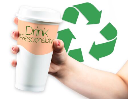 Recycle Logo behind Takeaway Coffee Cup held in young female handの写真素材