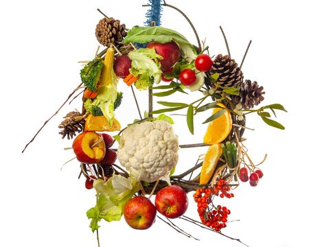 Fruit and Vegetable Christmas themed Ornamental Wreath on a White Backgroundの写真素材